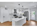 Renovated kitchen featuring a large island, stainless steel appliances, and pendant lighting at 2336 E Flower St, Phoenix, AZ 85016
