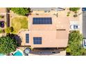 Aerial view of a home with a pool, patio, lawn and solar panels on the roof at 283 W Tahiti Dr, Casa Grande, AZ 85122