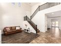 Bright foyer features soaring ceilings, elegant staircase, and an inviting seating area at 283 W Tahiti Dr, Casa Grande, AZ 85122