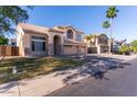 Stucco two-story home boasts a three-car garage, desert landscaping, and tile roof in a suburban setting at 2880 E Nunneley Rd, Gilbert, AZ 85296
