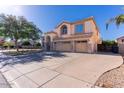 Two-story stucco home with stone accents, three car garage, and well manicured landscaping in a suburban neighborhood at 2880 E Nunneley Rd, Gilbert, AZ 85296