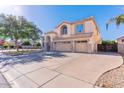 Two-story home with a three-car garage, neutral stucco, stone accents, and a large cement driveway at 2880 E Nunneley Rd, Gilbert, AZ 85296