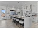 Bright kitchen featuring white cabinets, quartz countertops, pendant lighting, and stainless steel appliances at 300 S Charleston Ct, Casa Grande, AZ 85194