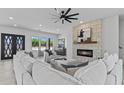 Spacious living room with a cozy stone fireplace and large windows providing natural light at 300 S Charleston Ct, Casa Grande, AZ 85194