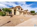 Home with a three-car garage and low-maintenance desert landscaping at 3132 E Wildwood Dr, Phoenix, AZ 85048
