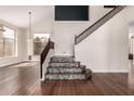 Bright foyer featuring beautiful hardwood floors and staircase with mosaic details at 3132 E Wildwood Dr, Phoenix, AZ 85048