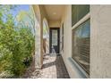 Inviting covered entryway with a decorative front door and tiled flooring at 3310 E Los Gatos Dr, Phoenix, AZ 85050