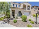 Beautiful home with an arched entryway, manicured landscaping, and a paver driveway at 3310 E Los Gatos Dr, Phoenix, AZ 85050