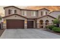 Beautiful two-story home featuring a three-car garage, stone accents, and desert landscaping at 3715 W Teresa Dr, New River, AZ 85087