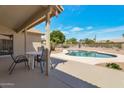 Covered patio that overlooks a pristine private backyard pool with lush landscaping at 3755 N 151St Ave, Goodyear, AZ 85395