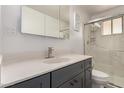 Bathroom featuring a gray vanity, white marble countertops, modern mirror, and glass-enclosed shower at 39 N Maple St, Mesa, AZ 85205