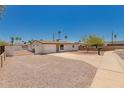 Single-story home featuring low maintenance desert landscaping, a spacious gravel yard, and driveway at 39 N Maple St, Mesa, AZ 85205