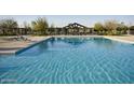 Well-maintained community pool with plenty of room for swimming and relaxing in the sun at 4083 E Rustler Way, Gilbert, AZ 85297