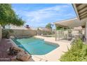Backyard pool featuring rock details and a privacy fence, perfect for relaxing and entertaining outdoors at 4213 W Calle Lejos --, Glendale, AZ 85310