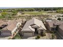 An aerial view showcasing the home's layout, tile roof, landscaping, and the surrounding golf course community at 4316 E Strawberry Dr, Gilbert, AZ 85298