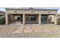 Covered back patio featuring three archways, neutral stucco, and low-maintenance desert landscaping at 4316 E Strawberry Dr, Gilbert, AZ 85298