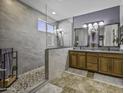 Modern bathroom featuring a large shower with glass enclosure and double vanity at 43330 W Delia Blvd, Maricopa, AZ 85138