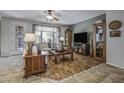 Inviting living room with hardwood floors, comfortable seating, and natural light at 43330 W Delia Blvd, Maricopa, AZ 85138