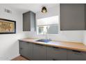 Modern kitchen sink with undermount sink, butcher block countertops, and gray cabinets at 4600 N 68Th St # 370, Scottsdale, AZ 85251
