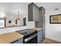 Modern kitchen featuring sleek gray cabinetry, stainless steel appliances, and butcher block countertops at 4600 N 68Th St # 370, Scottsdale, AZ 85251