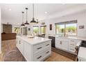 Bright kitchen with white cabinets, large island, and views of the pool at 4727 E Rancho Caliente Dr, Cave Creek, AZ 85331