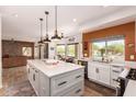 Bright kitchen with large island, stainless appliances, and breakfast nook with pool view at 4727 E Rancho Caliente Dr, Cave Creek, AZ 85331