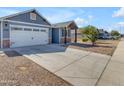 View of the home with a long driveway and two-car garage, showcasing its curb appeal at 4732 S 38Th Gln, Phoenix, AZ 85041