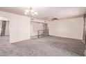 Open concept living space with ceiling fan, carpet, and metal railing to the right at 501 E Hill Dr, Avondale, AZ 85323