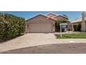 Inviting single-story home with a spacious driveway and desert landscaping at 51 N Rush St, Chandler, AZ 85226