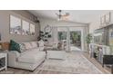 Open living room featuring a comfortable sectional sofa and sliding glass doors to the backyard at 51 N Rush St, Chandler, AZ 85226