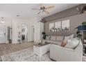Bright living room with a cozy sectional sofa, ceiling fan, and stylish decor at 51 N Rush St, Chandler, AZ 85226
