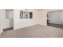 Bright living room featuring neutral carpeting and decor, perfect for relaxation and entertaining at 5415 E Butte St, Mesa, AZ 85205