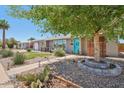 Charming single-story home featuring desert landscaping, mature trees, and a delightful front porch with seating at 5614 N 20Th Dr, Phoenix, AZ 85015