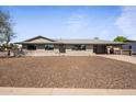 Charming single-story home with desert landscaping and attached carport on a sunny day at 6802 E Oak St, Scottsdale, AZ 85257
