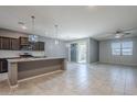 Open-concept kitchen showcasing a spacious island, modern pendant lights, and tile flooring at 7261 E Teal Way, San Tan Valley, AZ 85143