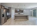 Well-designed kitchen featuring stainless steel appliances and an oversized kitchen island at 7261 E Teal Way, San Tan Valley, AZ 85143