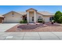 Inviting single-story home with desert landscaping, well-manicured lawn, and charming curb appeal at 8449 W Rockwood Dr, Peoria, AZ 85382