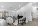 Open living area with neutral decor, vaulted ceilings, tile floors, and ample seating at 8449 W Rockwood Dr, Peoria, AZ 85382