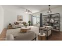 Bright living room with modern furnishings, neutral tones, ceiling fan, and sliding doors to the outdoor patio at 8552 E Indian School Rd # B, Scottsdale, AZ 85251