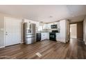 Well-lit kitchen showcases white cabinets, stainless steel appliances, and dark countertops on a wood-look floor at 8600 E Broadway Rd # 53, Mesa, AZ 85208