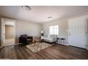 Inviting living room shows neutral paint, modern furniture, and wood-look floors with an open floor plan at 8600 E Broadway Rd # 53, Mesa, AZ 85208