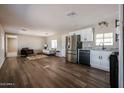 Open-concept living space shows the kitchen, living room, and an abundance of natural light at 8600 E Broadway Rd # 53, Mesa, AZ 85208