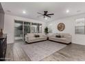Spacious living room with wood-look floors, neutral paint, and a sliding glass door for ample natural light at 9831 E Tupelo Ave, Mesa, AZ 85212
