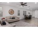 Open-concept floorplan featuring wood-look floors, comfortable seating area, and a dining space at 9831 E Tupelo Ave, Mesa, AZ 85212