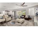 Open-concept living room featuring neutral tones, stylish furniture, and large windows with backyard views at 10310 E Tillman Ave, Mesa, AZ 85212