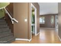 Inviting entryway showcases staircase, half-bath and wood-look floors at 1106 E Altadonna St, San Tan Valley, AZ 85140