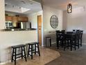 Open concept dining area and kitchen with breakfast bar and pendant lighting at 11680 E Sahuaro Dr # 2011, Scottsdale, AZ 85259