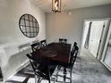 Dining room featuring a table with seating for six and a decorative round mirror on the wall at 11680 E Sahuaro Dr # 2011, Scottsdale, AZ 85259