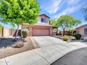 Beautiful home with a two-car garage, desert landscaping, and a covered front porch at 12706 W Pasaro Dr, Peoria, AZ 85383