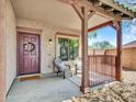 A welcoming front porch featuring comfortable seating, decorative accents, and a stylish front door at 12706 W Pasaro Dr, Peoria, AZ 85383